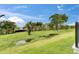 Spacious backyard with lush grass, a water view, and landscaping at 6528 Simone Shores Cir, Apollo Beach, FL 33572