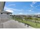 Balcony with tiled flooring, glass railing, and a panoramic view of neighborhood and sky at 6528 Simone Shores Cir, Apollo Beach, FL 33572