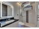Modern bathroom featuring dual shower heads, backlit mirror, and modern fixtures at 6528 Simone Shores Cir, Apollo Beach, FL 33572