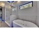 Bright bathroom boasts a soaking tub and walk-in shower with sleek, modern fixtures at 6528 Simone Shores Cir, Apollo Beach, FL 33572