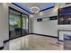 Bright dining area with tile floors, stylish chandelier, and sliding glass doors to an outdoor grill at 6528 Simone Shores Cir, Apollo Beach, FL 33572