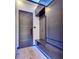 Contemporary entryway boasts custom storage with blue accent lighting, modern door, and wood-look flooring at 6528 Simone Shores Cir, Apollo Beach, FL 33572