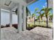View from the porch with stone pavers, modern railings, and lush landscaped front yard at 6528 Simone Shores Cir, Apollo Beach, FL 33572