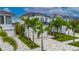 Beautiful two-story home with lush landscaping, a patterned driveway, and a white three-car garage at 6528 Simone Shores Cir, Apollo Beach, FL 33572