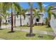 Well manicured lawn, driveway, and a white three-car garage at 6528 Simone Shores Cir, Apollo Beach, FL 33572