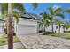 Two-story home with a paver driveway, manicured lawn, and a white garage door at 6528 Simone Shores Cir, Apollo Beach, FL 33572