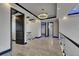 Upstairs hallway featuring glass railings, modern lighting fixtures and sleek tile floors at 6528 Simone Shores Cir, Apollo Beach, FL 33572