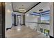 Bright hallway with modern chandelier, glass railings, and elegant trim at 6528 Simone Shores Cir, Apollo Beach, FL 33572