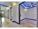 Open-concept floor plan hallway with wood-look tile floors and modern recessed lighting at 6528 Simone Shores Cir, Apollo Beach, FL 33572