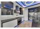 Beautiful modern kitchen with stainless steel appliances, a sleek black countertop, and stylish range hood at 6528 Simone Shores Cir, Apollo Beach, FL 33572