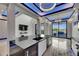 Open kitchen with black countertops, sleek cabinetry, and seamless flow into the living area at 6528 Simone Shores Cir, Apollo Beach, FL 33572