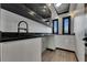 Bright laundry room with custom cabinets, black granite counters, and a stainless steel faucet at 6528 Simone Shores Cir, Apollo Beach, FL 33572