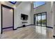 Spacious living room featuring fireplace, sleek floors, and access to outdoor balcony at 6528 Simone Shores Cir, Apollo Beach, FL 33572