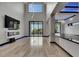 Spacious living room with fireplace, sleek flooring, and sliding glass doors to the outdoor deck at 6528 Simone Shores Cir, Apollo Beach, FL 33572
