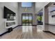 Spacious living room featuring fireplace, sleek floors, and access to outdoor balcony at 6528 Simone Shores Cir, Apollo Beach, FL 33572