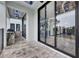 Covered outdoor kitchen with built-in grill and stone countertops, accessible through sliding glass doors at 6528 Simone Shores Cir, Apollo Beach, FL 33572