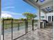Outdoor kitchen and dining area overlooking a pool surrounded by a secure black fence at 6528 Simone Shores Cir, Apollo Beach, FL 33572