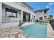 Beautiful backyard with a modern in-ground pool, patio, and outdoor seating area at 6528 Simone Shores Cir, Apollo Beach, FL 33572
