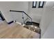 Modern staircase featuring glass railings, sleek black accents, and stylish floor tiles at 6528 Simone Shores Cir, Apollo Beach, FL 33572