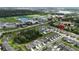 Aerial view of homes in a neighborhood near a school, athletic fields, and a pond at 6658 Devlin Ln, Wesley Chapel, FL 33545