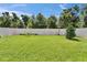 Large, well-maintained backyard featuring lush green grass and a pristine white fence at 6658 Devlin Ln, Wesley Chapel, FL 33545