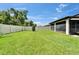 Spacious backyard featuring a manicured lawn and a white fence that offers privacy at 6658 Devlin Ln, Wesley Chapel, FL 33545