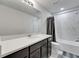 Bright bathroom featuring a modern vanity with a white countertop and a shower-tub combination at 6658 Devlin Ln, Wesley Chapel, FL 33545