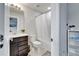 Bathroom with a single sink vanity, toilet, and a shower-tub combination with tile surround and white shower curtain at 6658 Devlin Ln, Wesley Chapel, FL 33545
