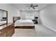 Bright bedroom features a ceiling fan, large window, and desk area for comfortable living at 6658 Devlin Ln, Wesley Chapel, FL 33545