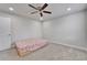 Bedroom with plush carpet, a modern ceiling fan, recessed lighting, and a bed featuring a patterned bedspread at 6658 Devlin Ln, Wesley Chapel, FL 33545