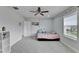 Bright bedroom featuring a ceiling fan, carpeted floors, and a cheerful aesthetic with a bed and decorations at 6658 Devlin Ln, Wesley Chapel, FL 33545