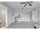 Bright bedroom with ceiling fan and open ensuite bathroom at 6658 Devlin Ln, Wesley Chapel, FL 33545