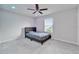 Bedroom featuring a modern platform bed, window with blinds, carpeted floors, and a contemporary ceiling fan at 6658 Devlin Ln, Wesley Chapel, FL 33545