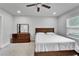 Comfortable bedroom with neutral tones, ceiling fan, a double bed, and a view of the outside at 6658 Devlin Ln, Wesley Chapel, FL 33545