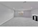 Bright bonus room featuring neutral colors, a window, and ample space for a variety of uses at 6658 Devlin Ln, Wesley Chapel, FL 33545