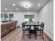 The dining area features recessed lighting, an elegant chandelier, and a large table with seating for six at 6658 Devlin Ln, Wesley Chapel, FL 33545