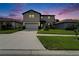 Beautiful two-story home with a well-manicured lawn and a freshly paved driveway at 6658 Devlin Ln, Wesley Chapel, FL 33545