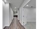 Hallway featuring sleek hardwood flooring and bright lighting leading into the home at 6658 Devlin Ln, Wesley Chapel, FL 33545