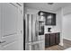 New stainless steel refrigerator and dark cabinets in a modern kitchen with white counters at 6658 Devlin Ln, Wesley Chapel, FL 33545