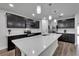 Stunning kitchen with quartz countertops, stainless steel appliances, and dark cabinets at 6658 Devlin Ln, Wesley Chapel, FL 33545