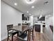 View of the dining area and kitchen with dark cabinets, stainless appliances, and white countertops at 6658 Devlin Ln, Wesley Chapel, FL 33545