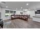 Open-concept living area features recessed lights, a sectional sofa, and a view of the dining area at 6658 Devlin Ln, Wesley Chapel, FL 33545