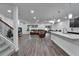 Open-concept living space with hardwood floors, light walls, and abundant natural light at 6658 Devlin Ln, Wesley Chapel, FL 33545