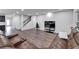 A living room showcasing recessed lighting, a comfortable couch, a staircase, and hard floors at 6658 Devlin Ln, Wesley Chapel, FL 33545