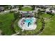 Aerial view of the community pool with a slide, lounge chairs, and clubhouse at 6658 Devlin Ln, Wesley Chapel, FL 33545
