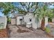 View of the backyard area of the home, with a palm tree and detached structure at 675 64Th S Ave, St Petersburg, FL 33705