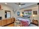 Cozy bedroom featuring a bed, mid-century modern decor, natural light, and a modern ceiling fan at 675 64Th S Ave, St Petersburg, FL 33705