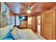 Bedroom with wood paneling, comfortable queen bed, and access to bathroom and living area at 675 64Th S Ave, St Petersburg, FL 33705