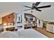 Bedroom with a sewing machine station, TV, wood flooring, and a slanted ceiling at 675 64Th S Ave, St Petersburg, FL 33705