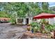 Home exterior with mature trees and manicured garden space at 675 64Th S Ave, St Petersburg, FL 33705